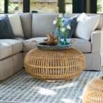 Living room with sectional and rattan coffee table; interior design trends, High Point Market, MGSD